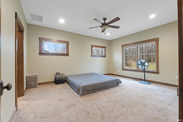 bedroom featuring light colored carpet and ceiling fan