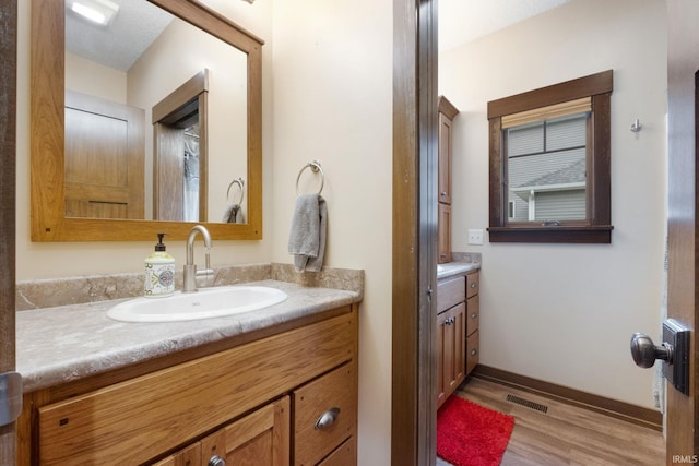 bathroom with vanity and hardwood / wood-style flooring