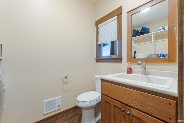 bathroom featuring hardwood / wood-style flooring, vanity, and toilet