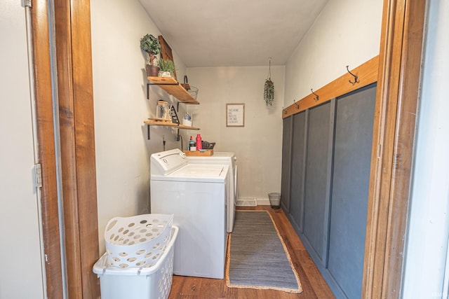 washroom featuring independent washer and dryer and dark hardwood / wood-style flooring