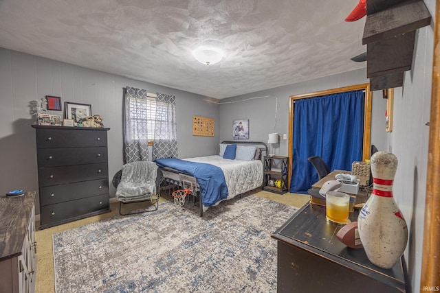 bedroom with a textured ceiling and wooden walls