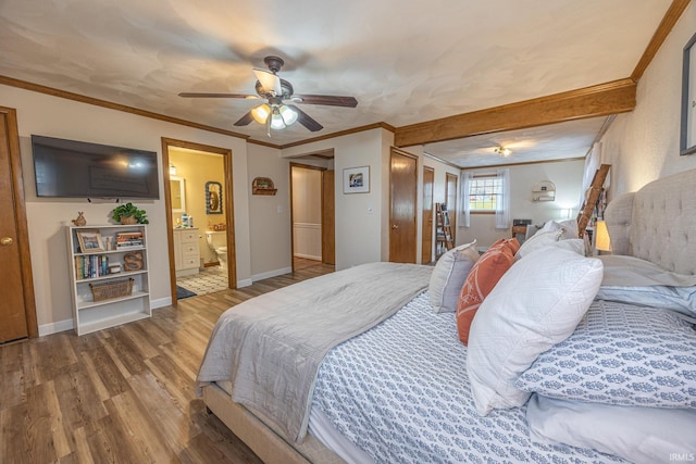 bedroom with ceiling fan, wood-type flooring, ornamental molding, and ensuite bath