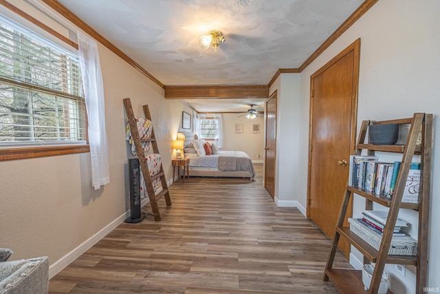 bedroom featuring hardwood / wood-style flooring, ornamental molding, and multiple windows