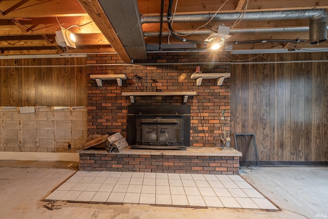 basement featuring a wood stove and wood walls