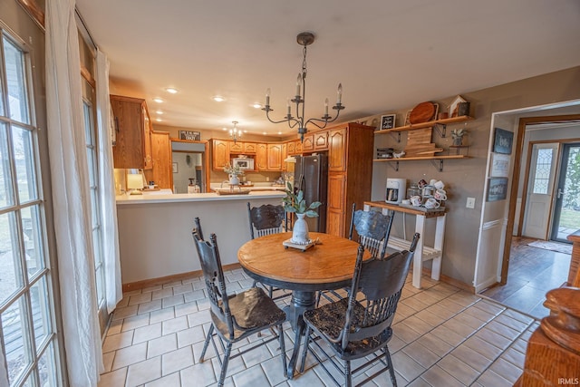 dining space featuring a chandelier and light tile patterned flooring