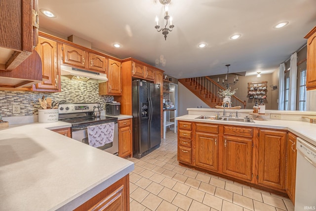 kitchen featuring stainless steel range with electric stovetop, dishwasher, sink, decorative light fixtures, and black fridge with ice dispenser