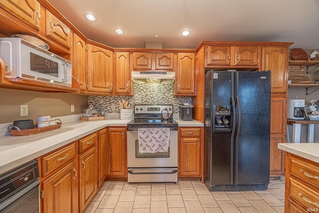 kitchen with stainless steel electric stove, black refrigerator with ice dispenser, tasteful backsplash, and light tile patterned floors