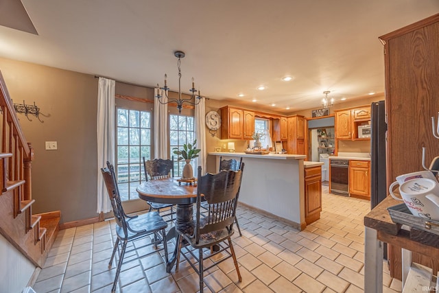 dining area featuring a chandelier and light tile patterned floors