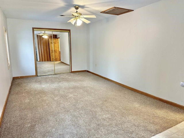 unfurnished bedroom featuring carpet, a closet, and ceiling fan