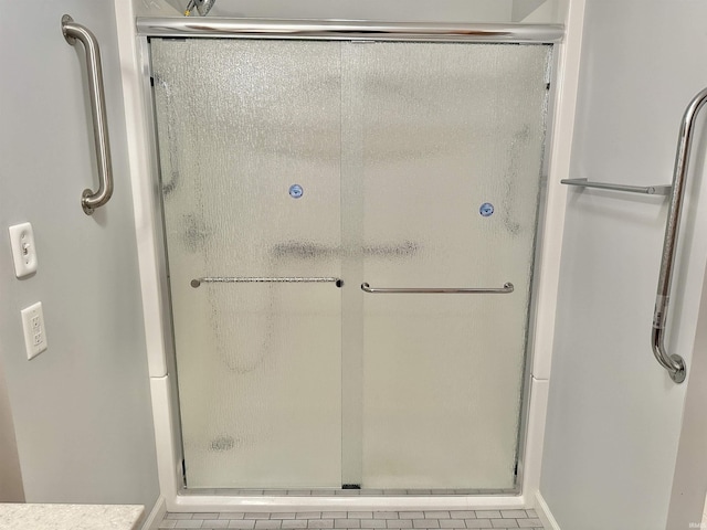 bathroom with tile patterned flooring and an enclosed shower