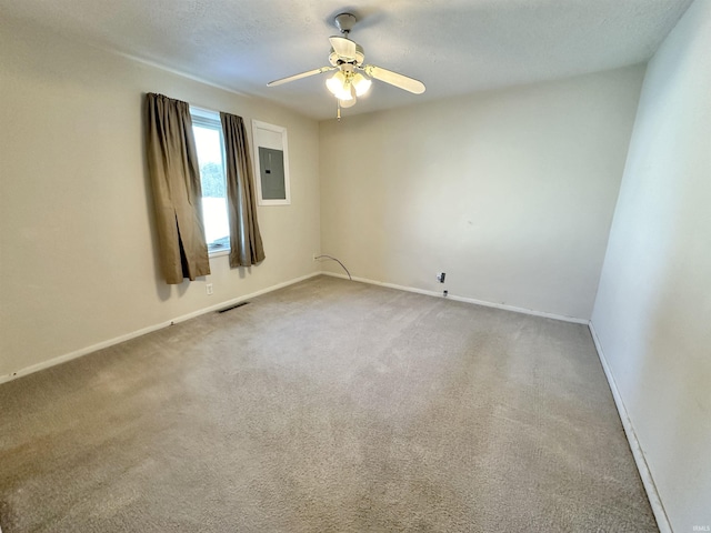 carpeted empty room with electric panel and ceiling fan