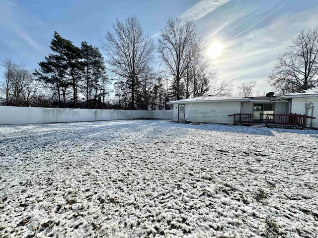 yard layered in snow featuring a wooden deck