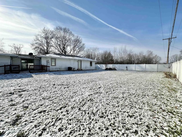 snowy yard featuring a deck