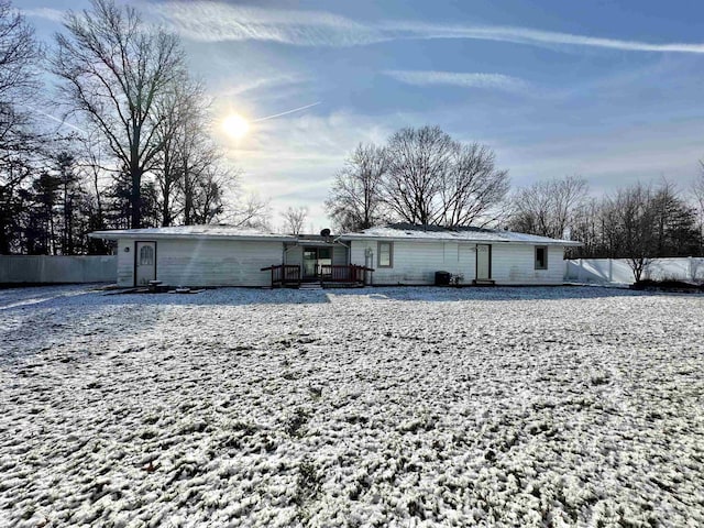 snow covered property featuring a wooden deck