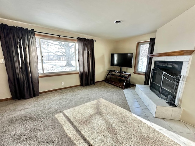 carpeted living room with a fireplace and a healthy amount of sunlight