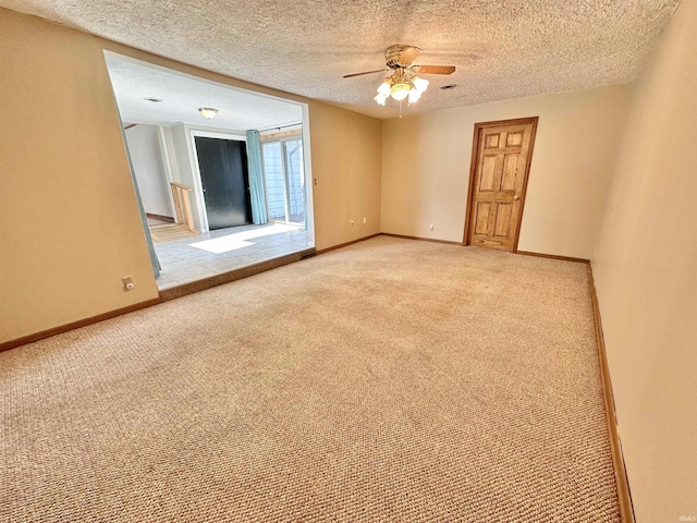 carpeted empty room with ceiling fan and a textured ceiling