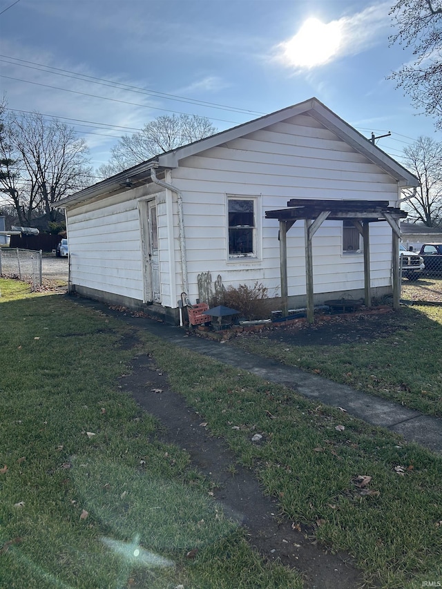 view of side of property with a lawn