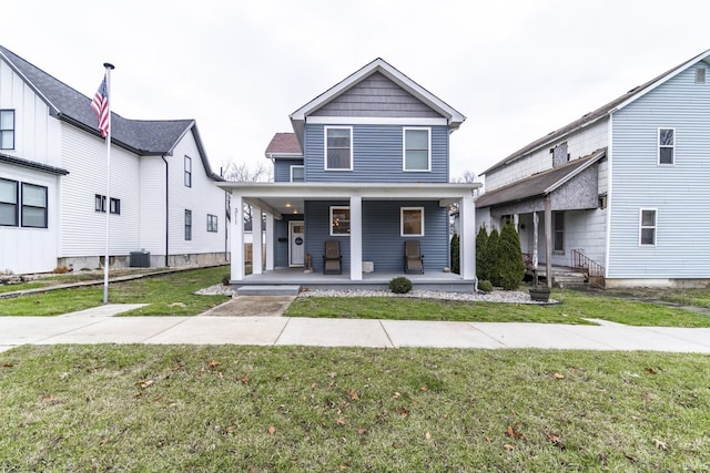 view of front of house featuring a front yard, a porch, and cooling unit