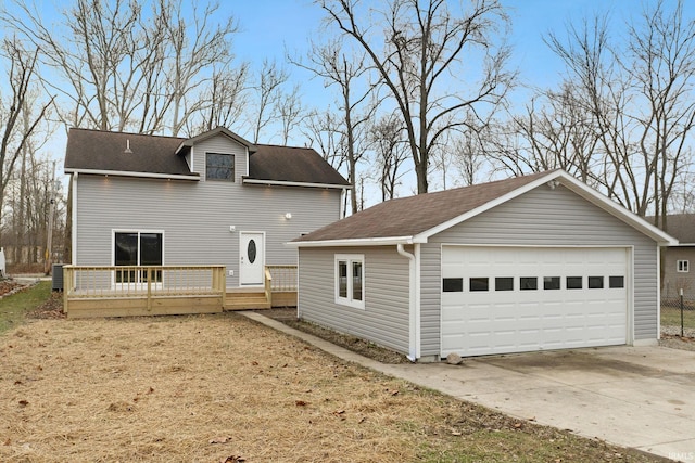 exterior space with a garage, central AC unit, and a deck