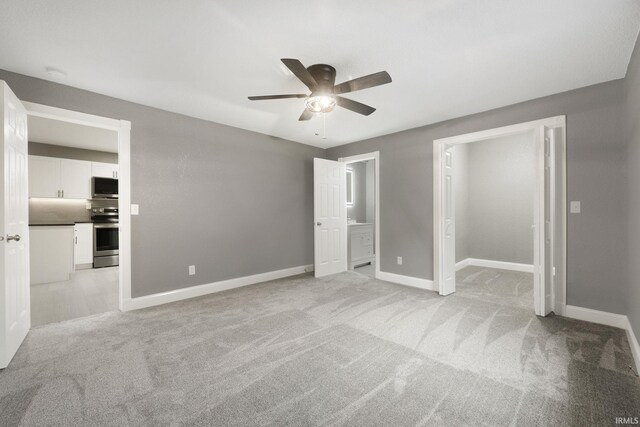 3598 W Huntington Ave 57th Ave, Columbia City, IN 46725 - unfurnished bedroom with ceiling fan, ensuite bathroom, and light carpet