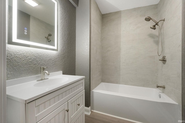 bathroom featuring vanity, hardwood / wood-style flooring, and shower / bathtub combination