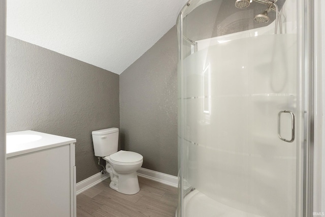 bathroom with an enclosed shower, vanity, hardwood / wood-style floors, toilet, and lofted ceiling