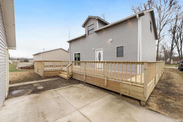 back of house featuring a patio and a deck