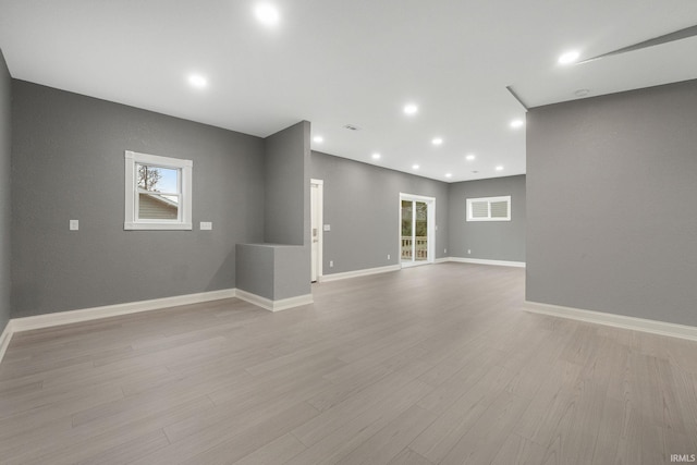 spare room featuring light hardwood / wood-style floors and a wealth of natural light