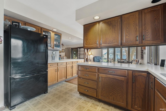 kitchen featuring kitchen peninsula and black fridge