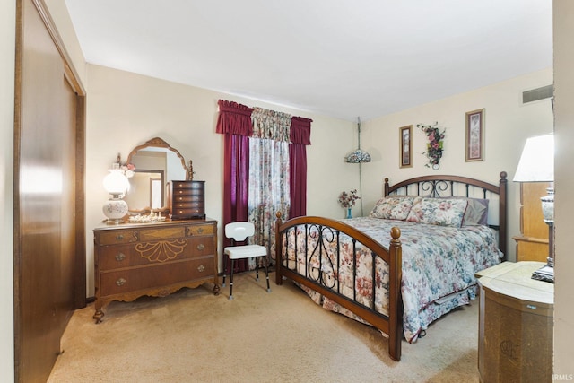 bedroom featuring light colored carpet and a closet