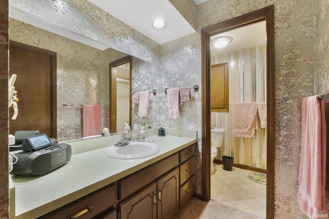 bathroom featuring vanity and toilet