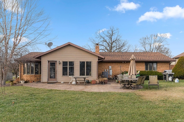 back of house with a patio, central AC, and a lawn