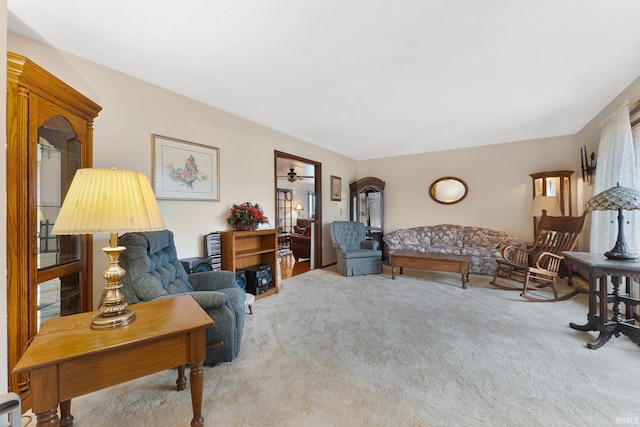 carpeted living room featuring ceiling fan