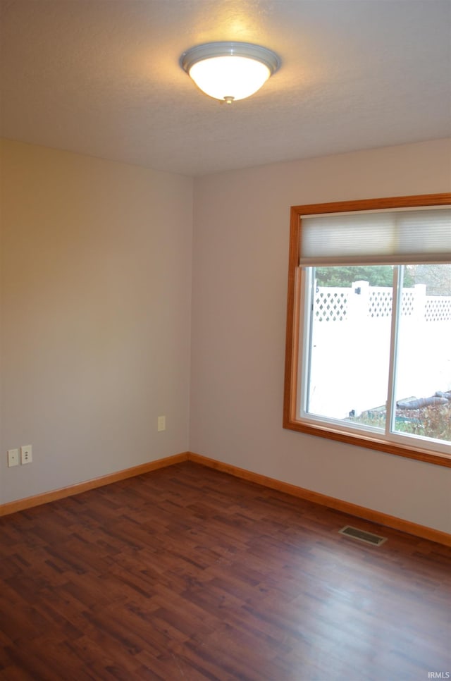 unfurnished room with dark hardwood / wood-style floors