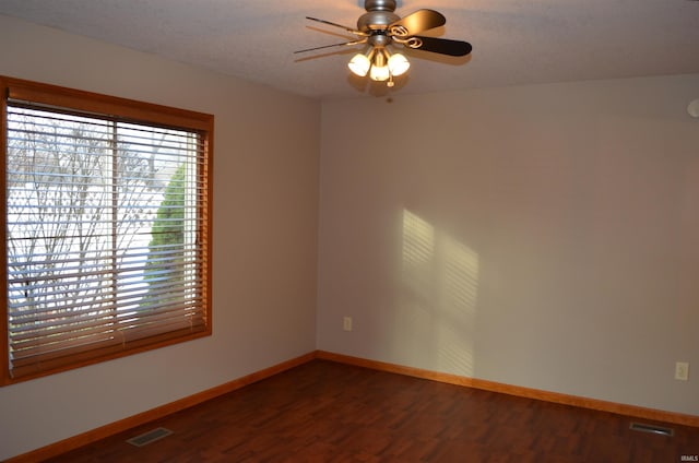 spare room featuring hardwood / wood-style floors and ceiling fan