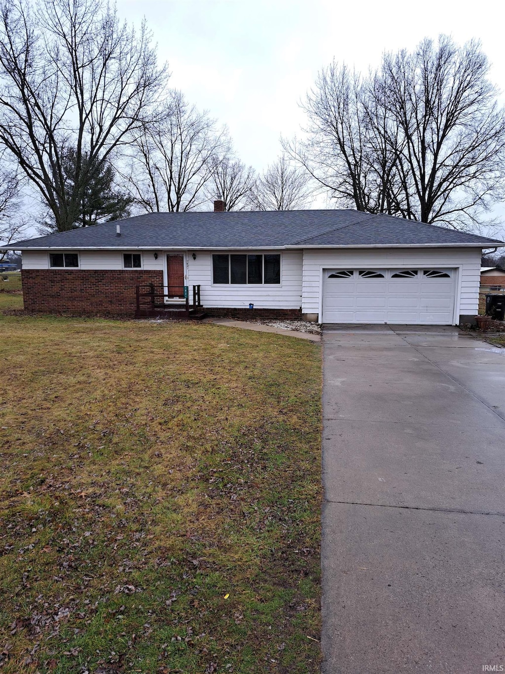 ranch-style house with a garage and a front yard