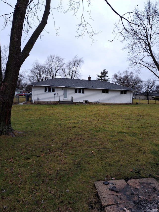 back of house with a lawn