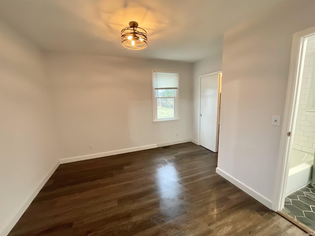 spare room featuring dark wood-type flooring