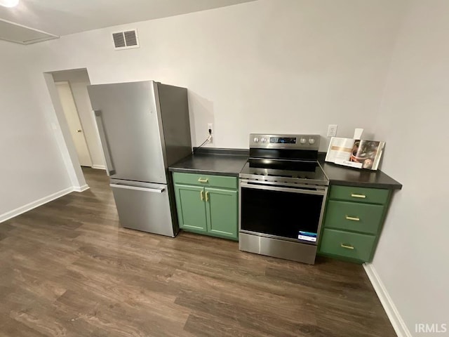 kitchen with green cabinets, dark hardwood / wood-style flooring, and appliances with stainless steel finishes