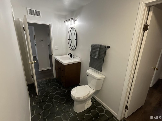 bathroom with tile patterned floors, vanity, and toilet