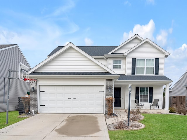 view of front of house with a garage, covered porch, and a front yard