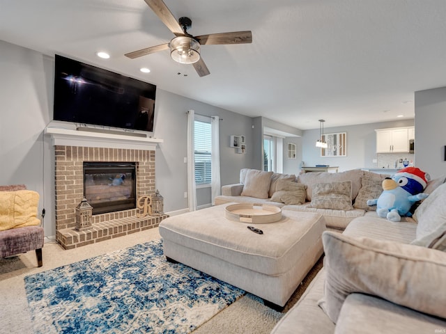 carpeted living room with ceiling fan, a fireplace, and billiards