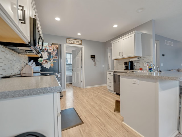 kitchen featuring tasteful backsplash, dishwasher, sink, and white cabinets