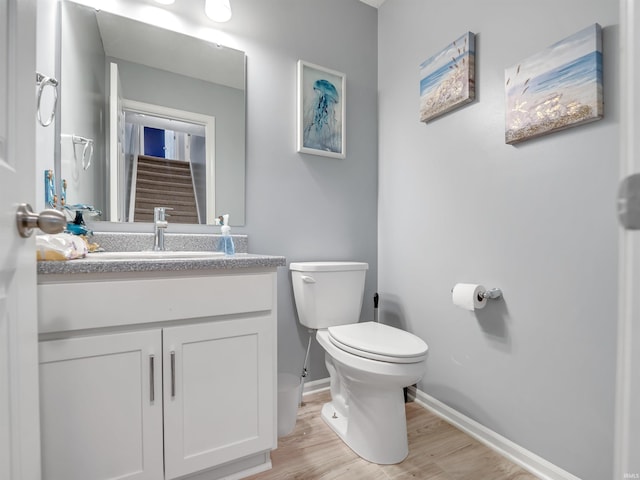 bathroom featuring hardwood / wood-style floors, vanity, and toilet