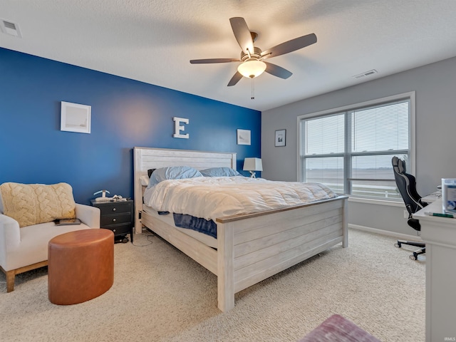 bedroom featuring carpet, a textured ceiling, and ceiling fan