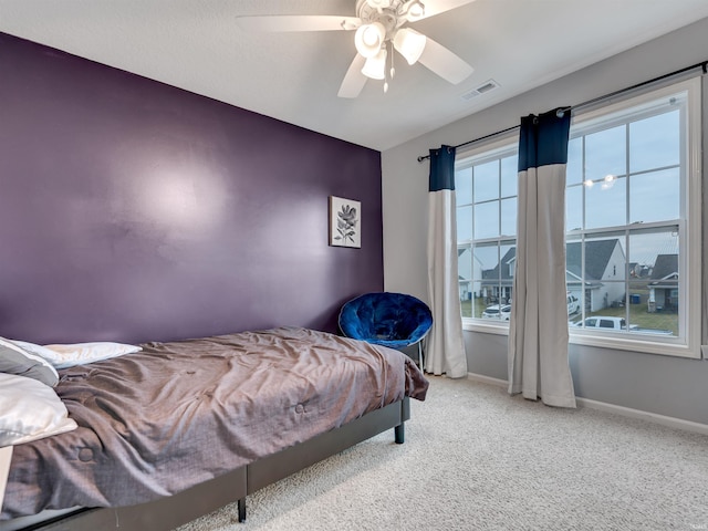 carpeted bedroom with ceiling fan