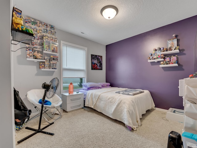 bedroom with carpet floors and a textured ceiling