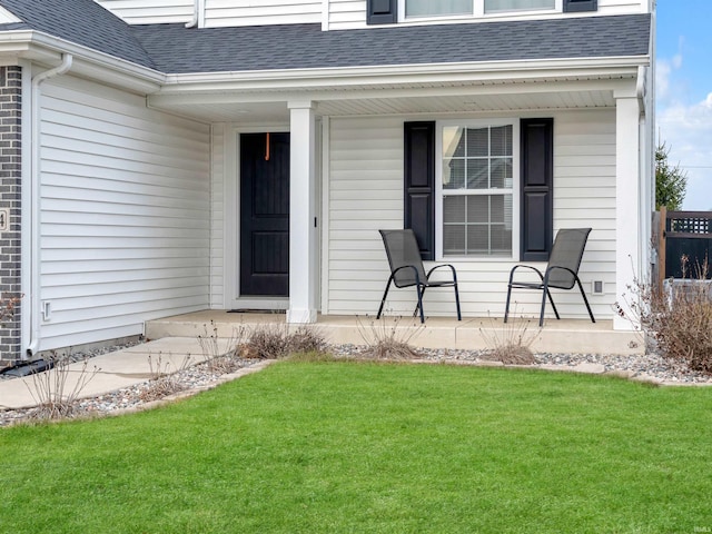 property entrance with a lawn