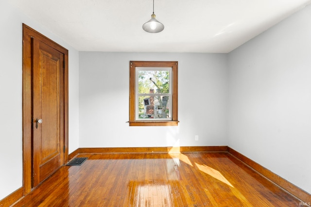 empty room with hardwood / wood-style flooring