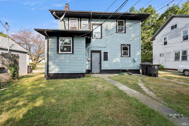 rear view of house with a yard